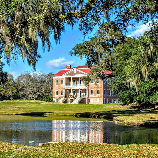 Historic Drayton Hall house viewed across a lawn and pond